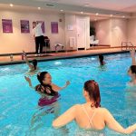 People in the pool doing a workout